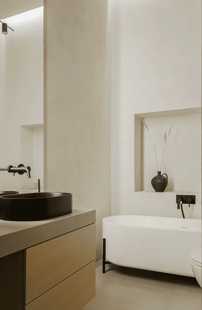 A bathroom with a sink, toilet and mirror.