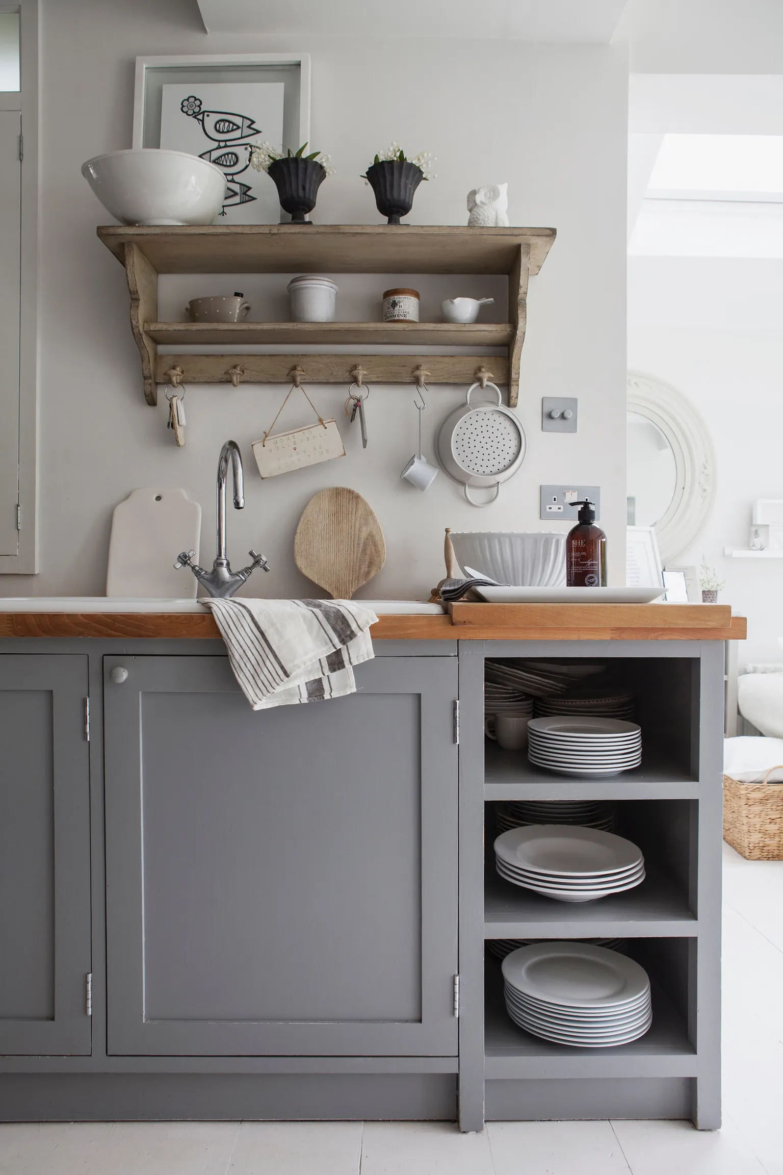 A kitchen with a lot of plates on the counter.