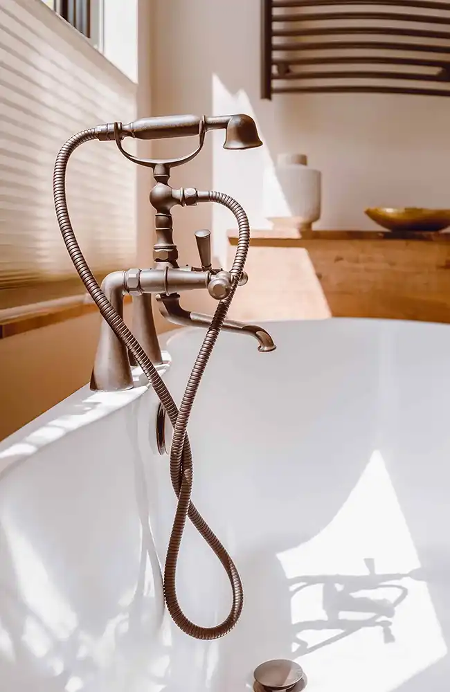A bathtub with a hose attached to it.